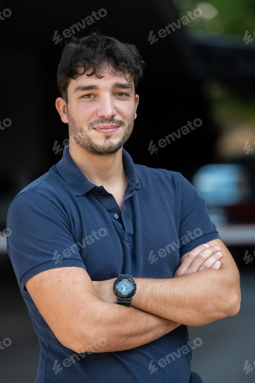 Preview: Portrait of a young successful entrepreneur in front of the company