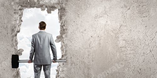 Preview: Young Businessman With Big Hammer Against Wall