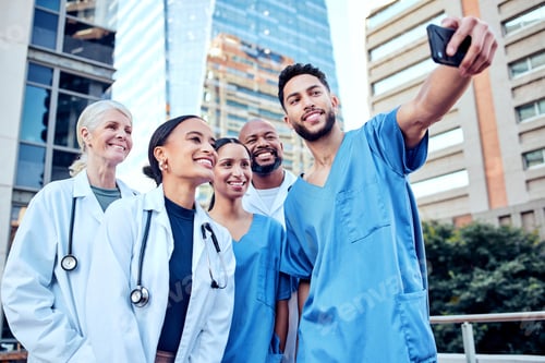 Preview: These doctors deserve a break. Shot of a group of doctors taking a selfie in the city.