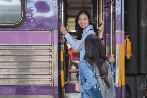Preview: Two happy female students boarding the train for their next travel adventure