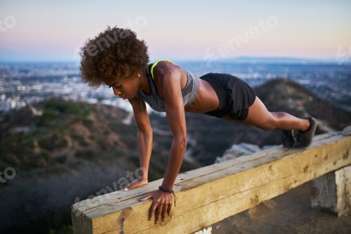 Preview: woman doing pushups on bench at runyon canyon after sunset
