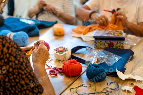 Preview: Crochet club. Elderly women knitting together in a workshop.
