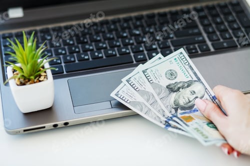 Preview: Closeup of One Female Caucasian Hand Holding Many Dollars