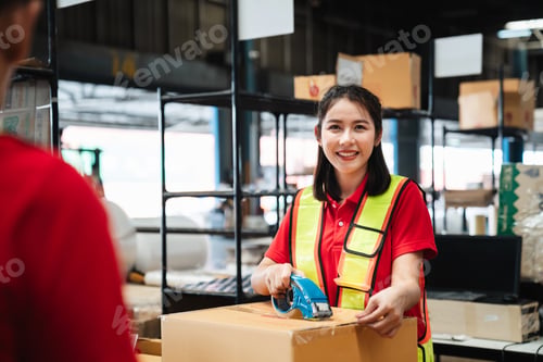 Preview: Warehouse worker checking and scanning a barcode on box package in the background warehouse.
