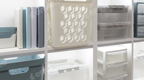 Preview: The concept of organizing home space and storing things. Plastic boxes and containers on the shelf