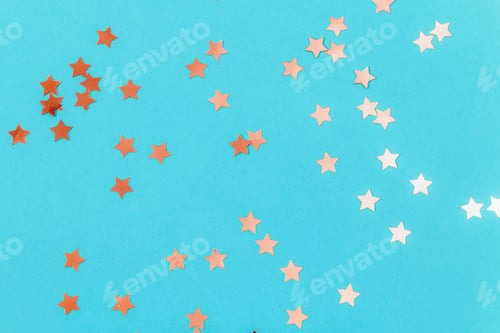 Preview: Golden confetti on blue background. Birthday party, holiday concept. Top view, copy space