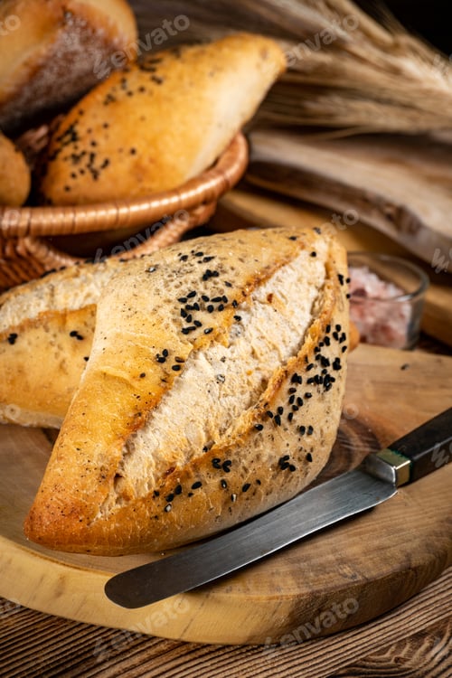 Preview: Fresh bread rolls on a rustic wooden table.