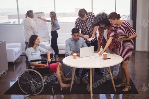 Preview: Handicap business people with colleagues in creative office