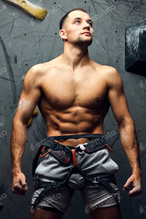Preview: Portrait of cheerful rock climber in indoor climbing gym