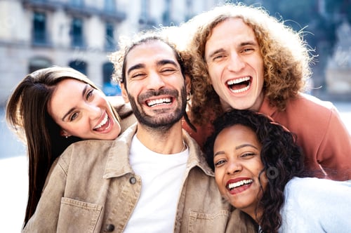 Preview: Multicultural students taking photo out side with backlight