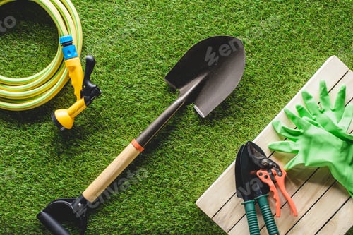 Preview: top view of hosepipe, protective gloves and gardening tools on grass