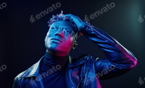 Preview: In glasses. Futuristic neon lighting. Young african american man in the studio