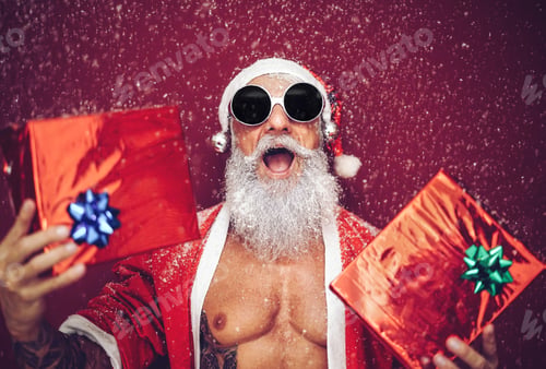 Preview: Happy fit santa claus laughing and giving christmas gifts