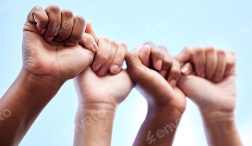 Preview: Shot of an unrecognisable group of women raising their hands in strength outside
