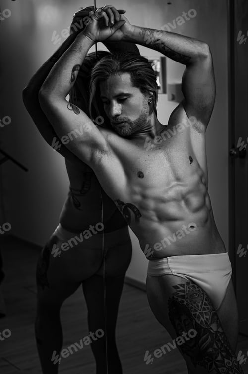 Preview: White Latin model of Venezuelan man posing for portrait, shirtless fitness body in front of mirror