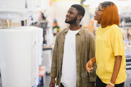 Preview: Happy african american young man and woman buying new heating water boiler