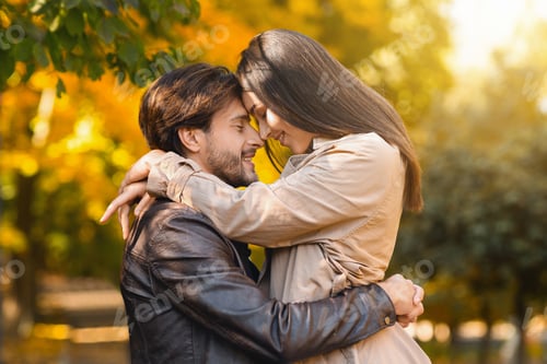 Preview: Loving couple cuddling over golden forest background