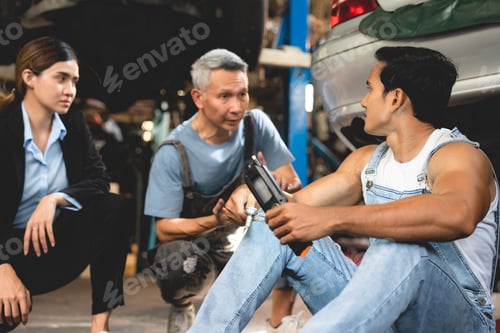 Preview: professional male technician mechanic man working to repair maintenance automobile at garage service