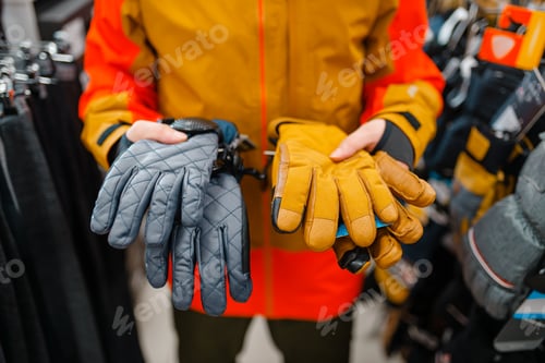 Preview: Man trying on gloves for ski or snowboarding