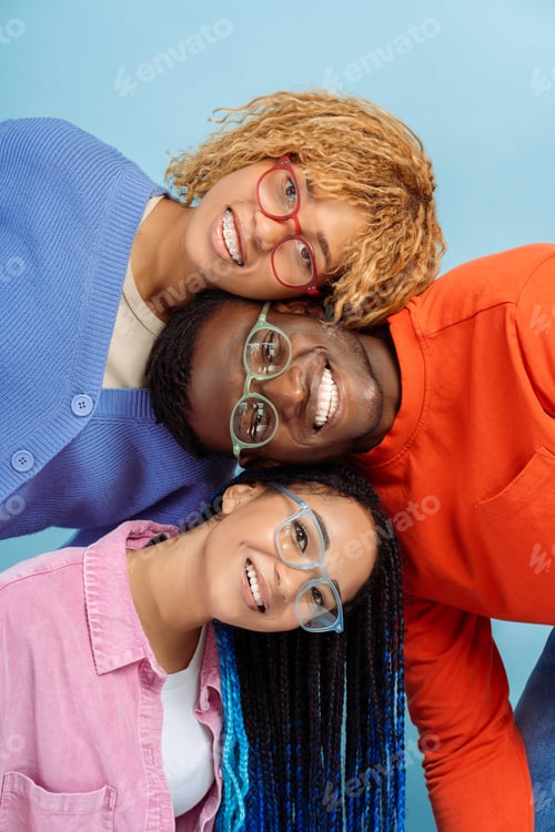 Preview: Group of smiling stylish African American friends wearing colorful glasses isolated on blue backgrou