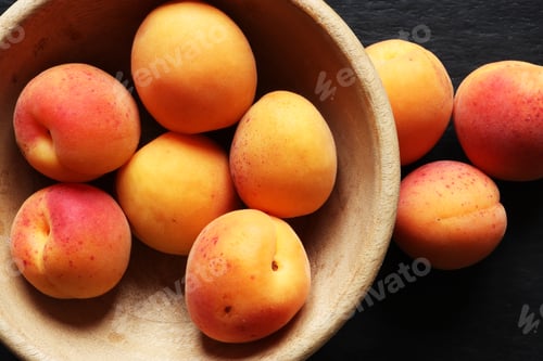 Preview: Photography of apricots in a wooden bowl, on slate background for food illustrations