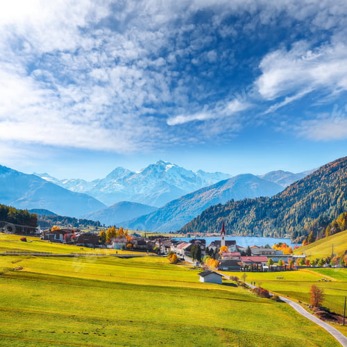 Preview: Fabulous autumn view of St.Valentin village and Haidersee lake with Ortler peak on background.