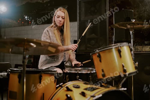 Preview: Woman Plays Drums with Sticks in a Music Room