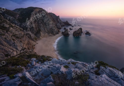 Preview: Sunset over a hidden surreal Praia Da Ursa Beach near Cabo Da Roca on Atlantic coast, Portugal