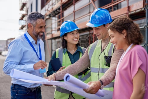 Preview: Smiling architects and happy engineers on construction site