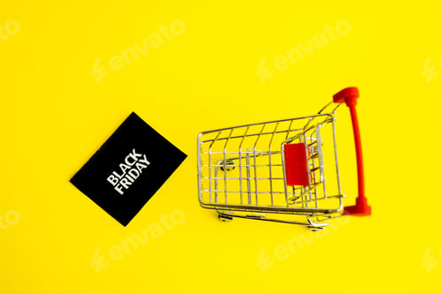 Preview: Shopping cart, and a black square that says black Friday on a yellow background. The topic of sales.