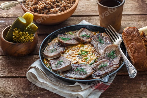 Preview: Beef tongue in cast iron skillet with cream sauce, rustic style.