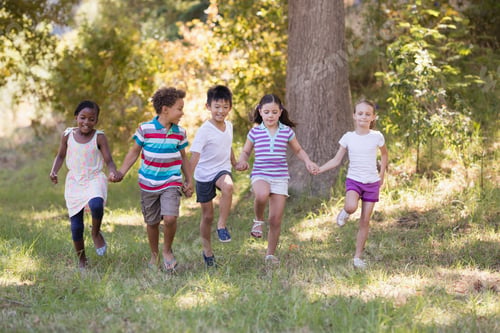 Preview: Friends holding hands while running at campsite