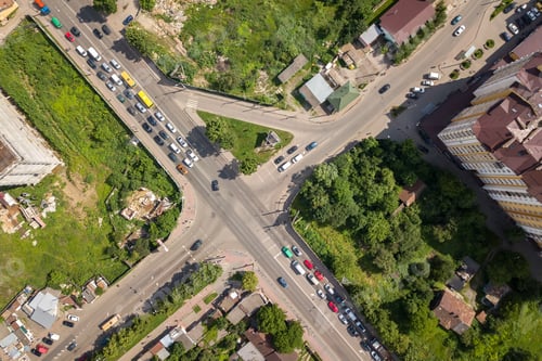 Preview: Top down aerial view of busy street intersection with moving cars traffic.