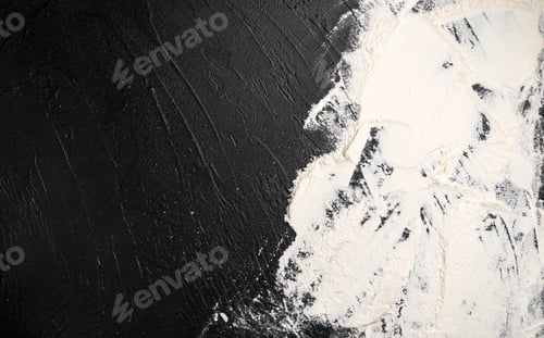Preview: Sprinkled wheat flour on black stone background