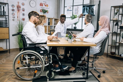 Preview: Multi ethnic doctors discussing results of x ray scan