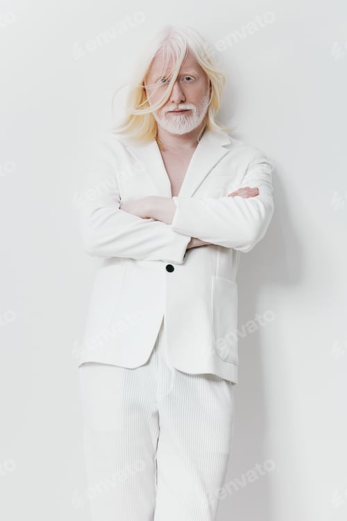 Preview: Stylish elderly man in a white suit standing confidently against a light background The man s long