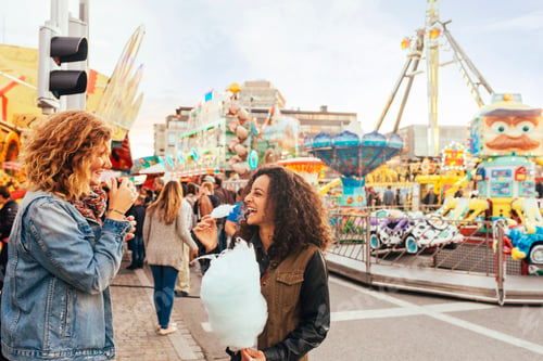 Preview: Friends eating cotton candy in amusement park