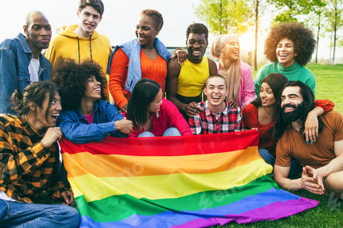 Preview: Diverse people having fun holding LGBT rainbow flag outdoor - Focus on gay man face