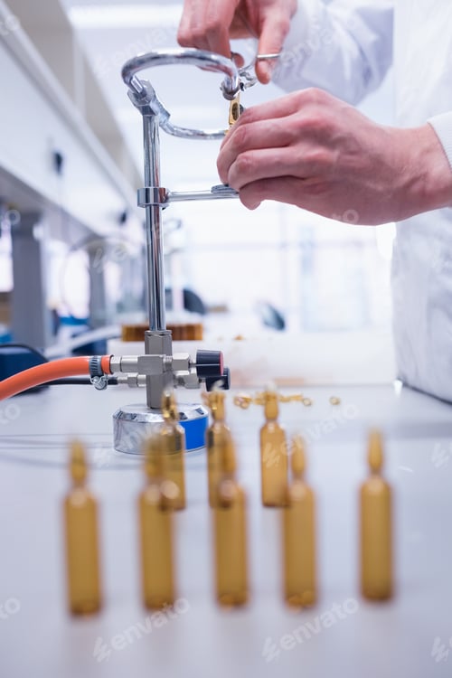 Preview: Close up of a biochemist sealing a vial in laboratory