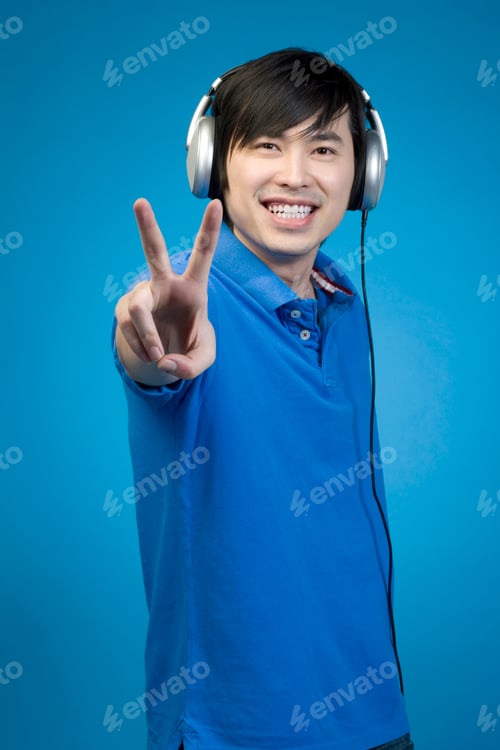 Preview: Man listening to headphones and giving peace sign