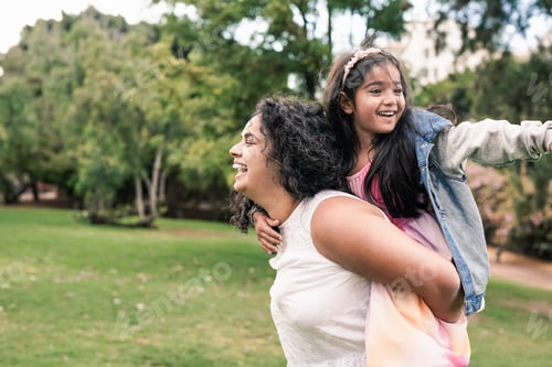 Preview: Indian mother and child having playful time at city park - Family love concept