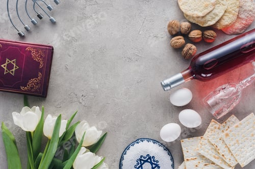 Preview: top view of traditional book with text in hebrew, kippah and menorah on concrete table