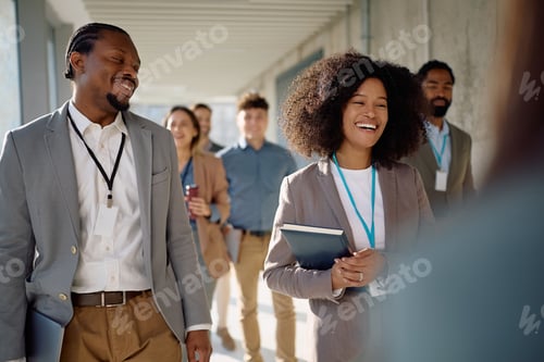 Preview: Happy entrepreneurs going on a business seminar at convention center.
