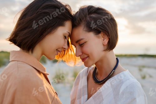 Preview: Two women standing face to fase on beach