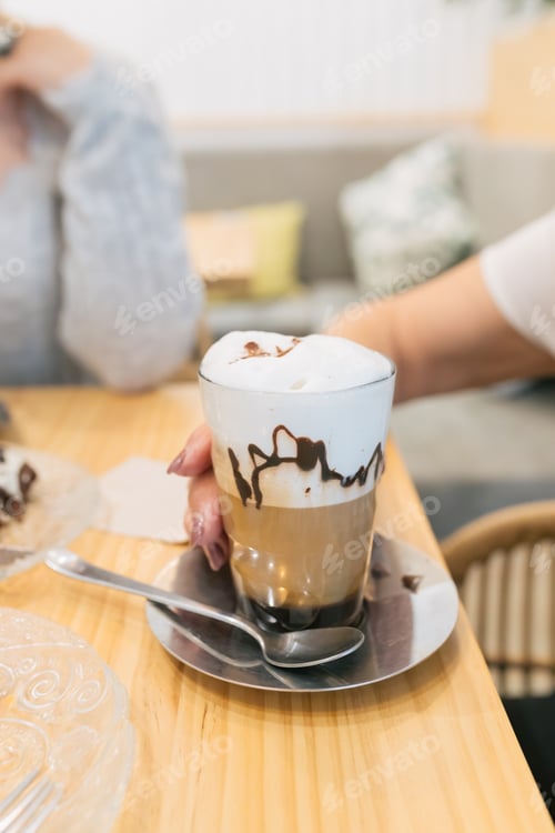 Preview: Latte macchiato coffee served in glass in cafeteria