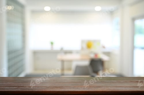 Preview: Empty wood table against blurred bright home office interior background.