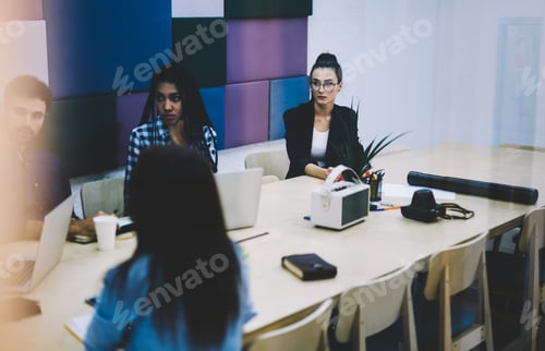 Preview: Multiethnic team having meeting in modern office
