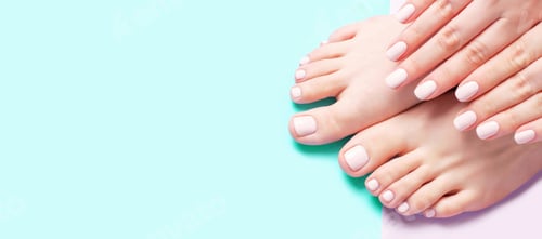 Preview: Female hands with manicure and pedicure on pink and mint background.