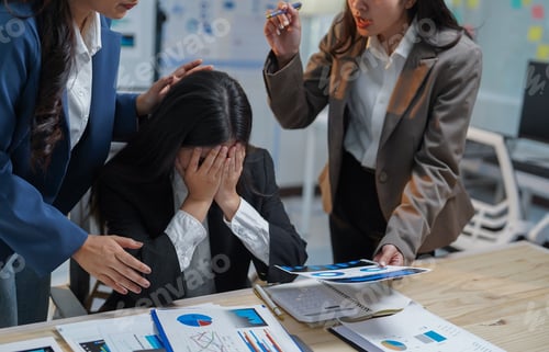 Preview: Businesswomen providing comfort to a stressed colleague while another displays disappointing financi