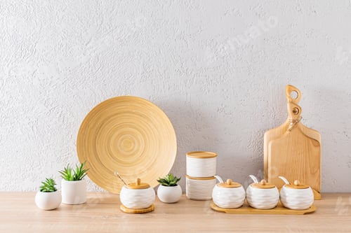Preview: A set of white ceramic storage jars and wooden boards in the interior of an eco-friendly kitchen